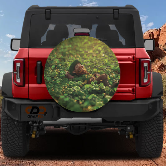 a red Jeep Wrangler with a large round decal on the rear window depicting a person lying in a field of green grass.