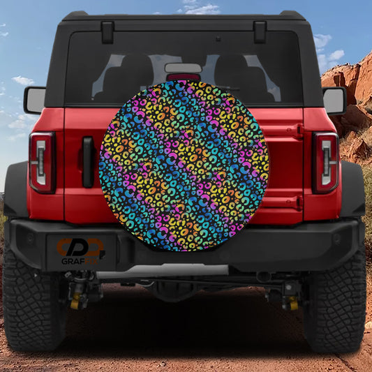 the rear view of a red Jeep Wrangler with a colorful, multicolored wheel cover attached to the vehicle.