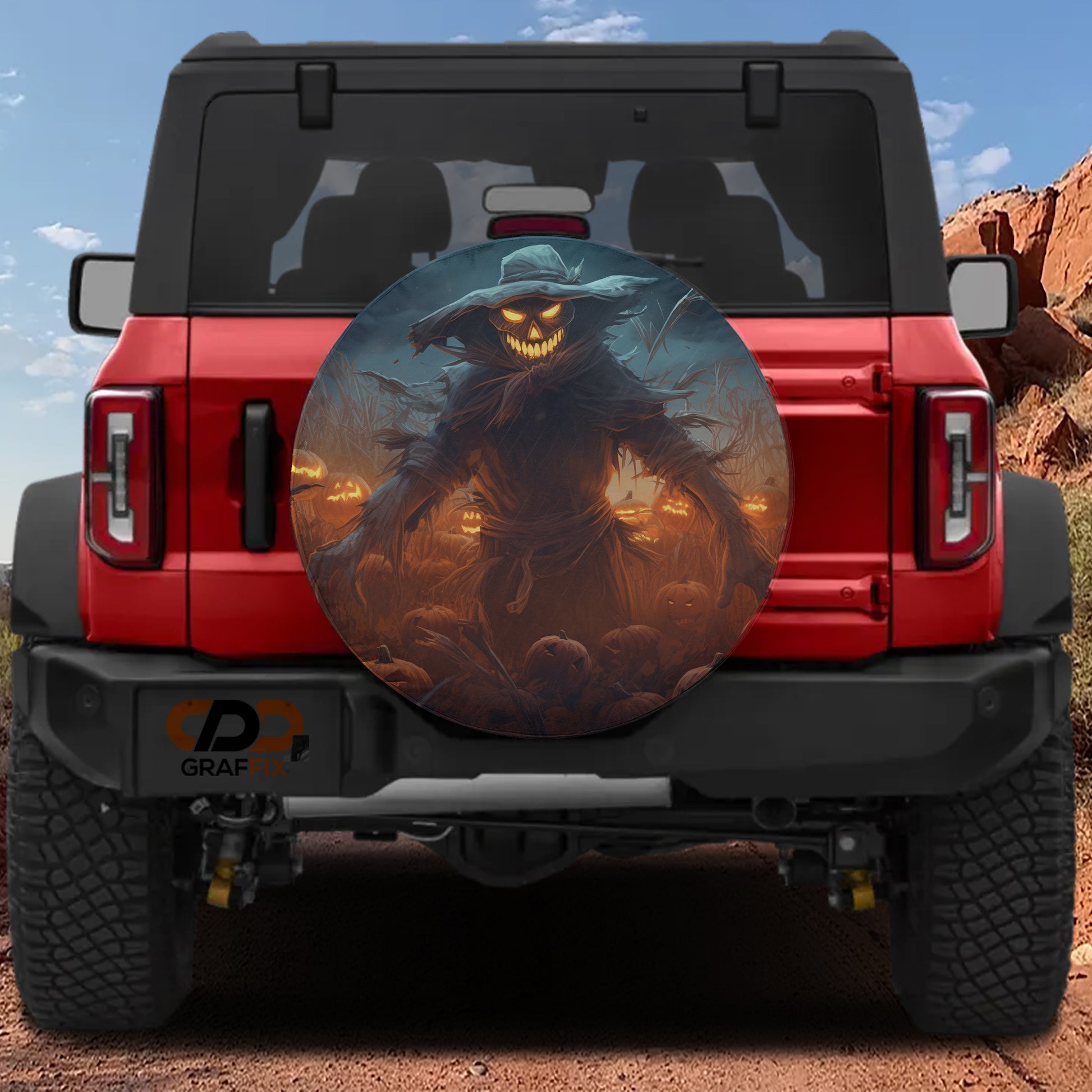 a red Jeep Wrangler with a large, eerie-looking wheel cover depicting a creepy figure with glowing eyes and a menacing expression.