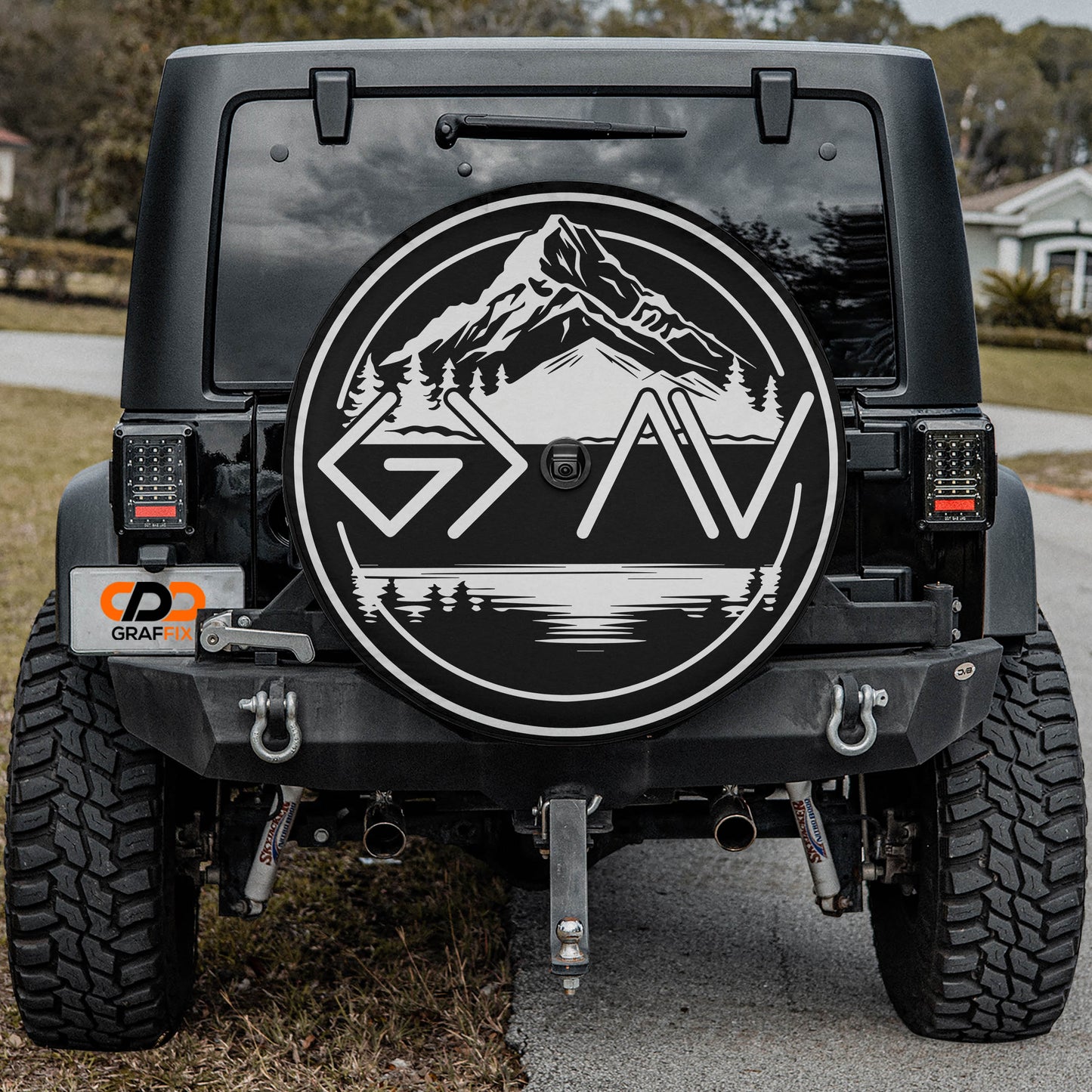 the back of a black Jeep Wrangler with a large graphic decal on the rear window.