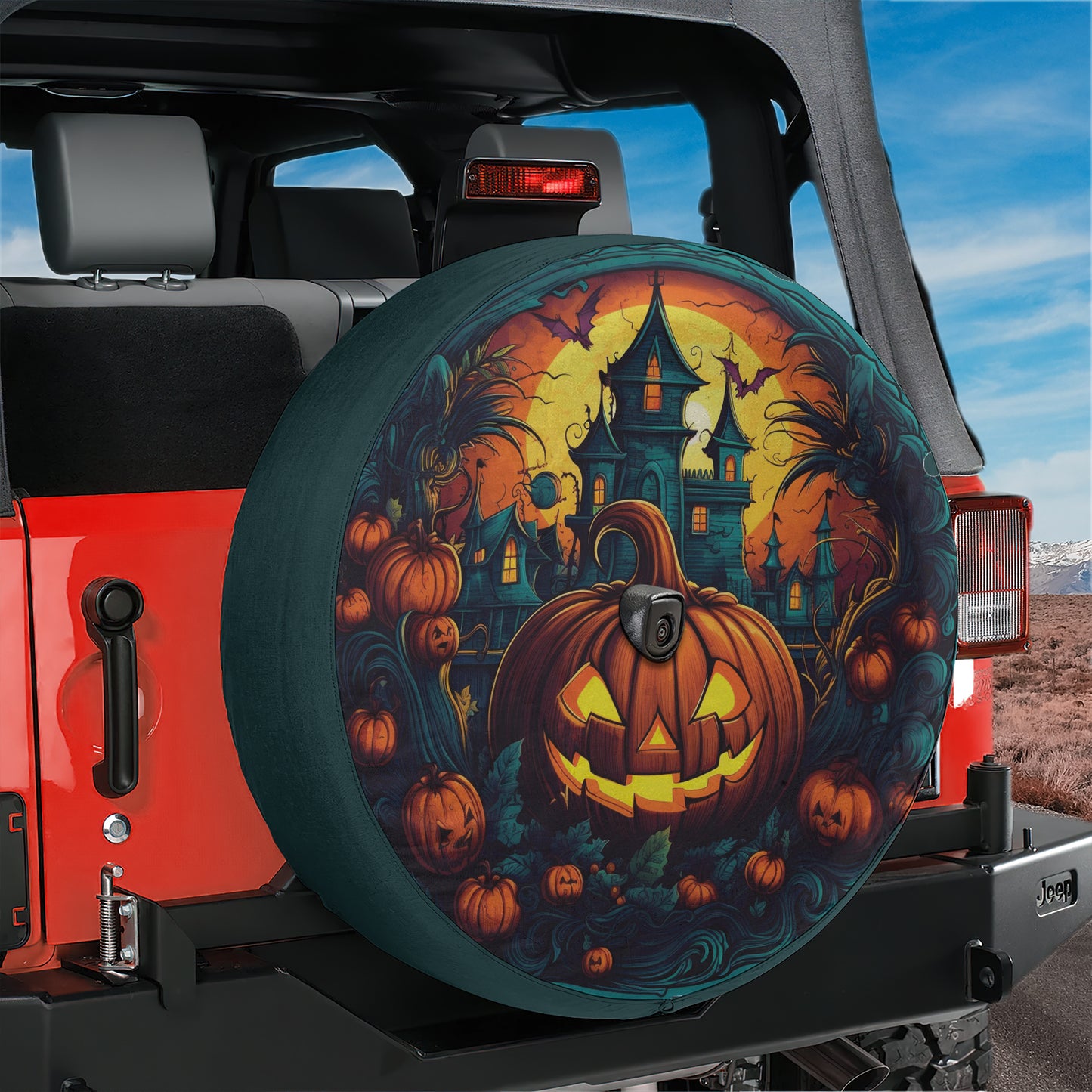 A Halloween-themed spare tire cover for a Jeep, featuring a jack-o-lantern and a castle-like structure.
