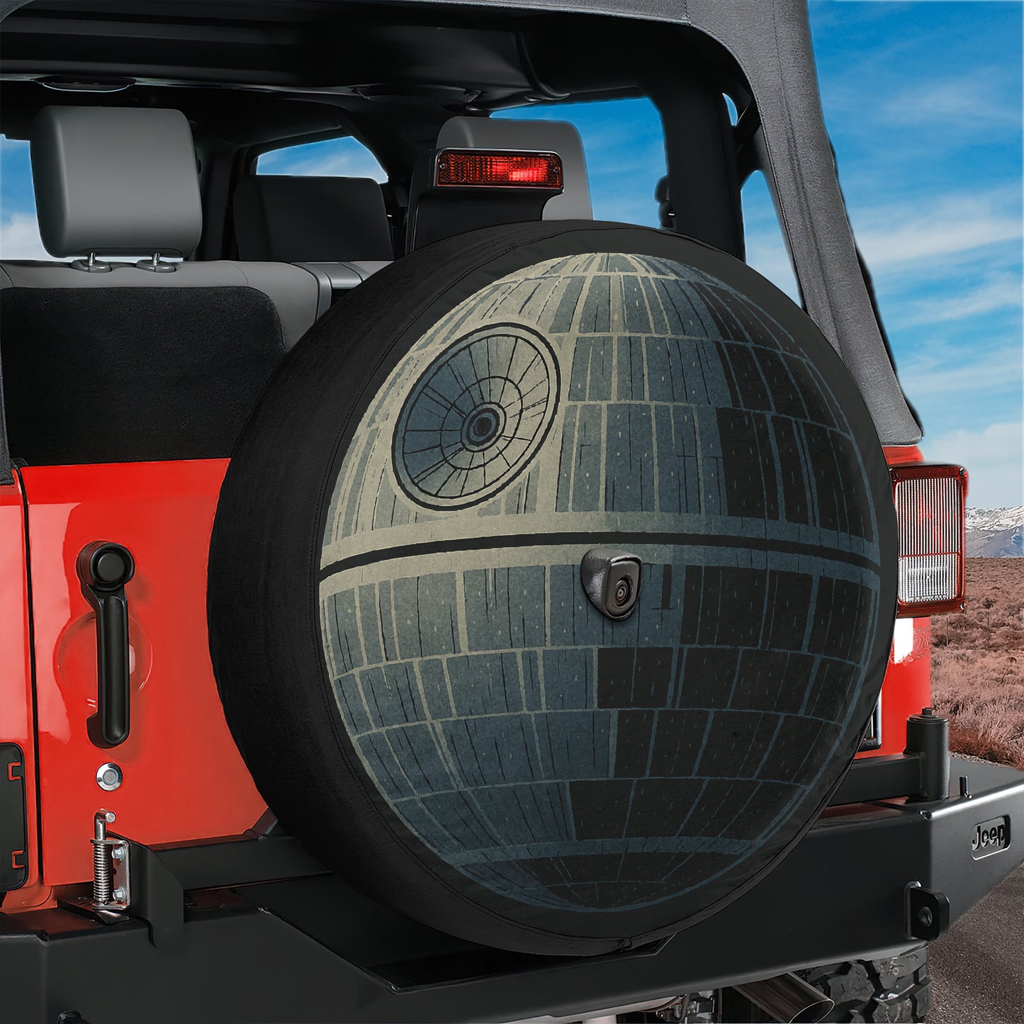 A red Jeep Wrangler with a Star Wars Death Star-themed spare tire attached to the rear.