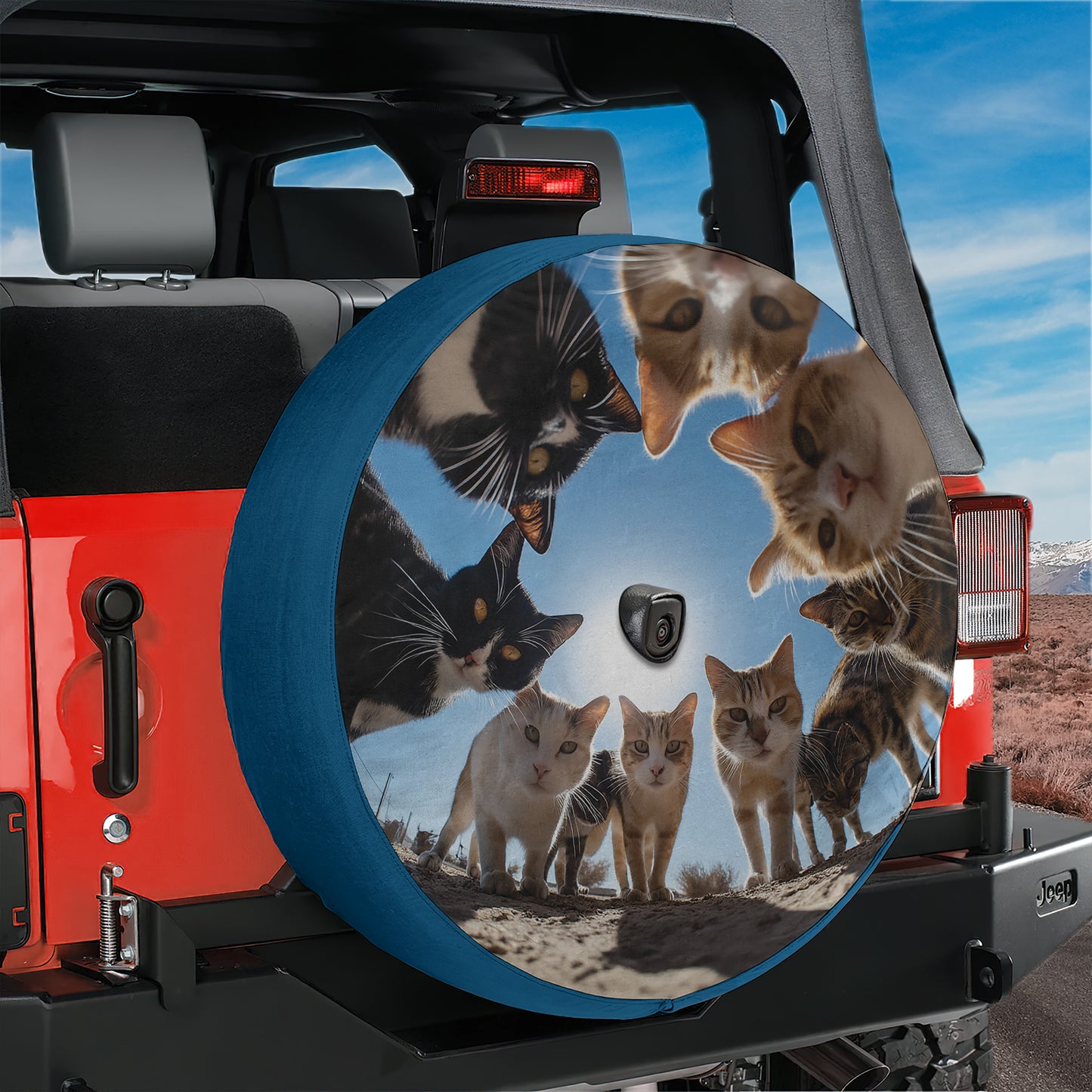 A large, round spare tire cover on a Jeep vehicle, featuring a collage of multiple cat images arranged in a circular pattern.