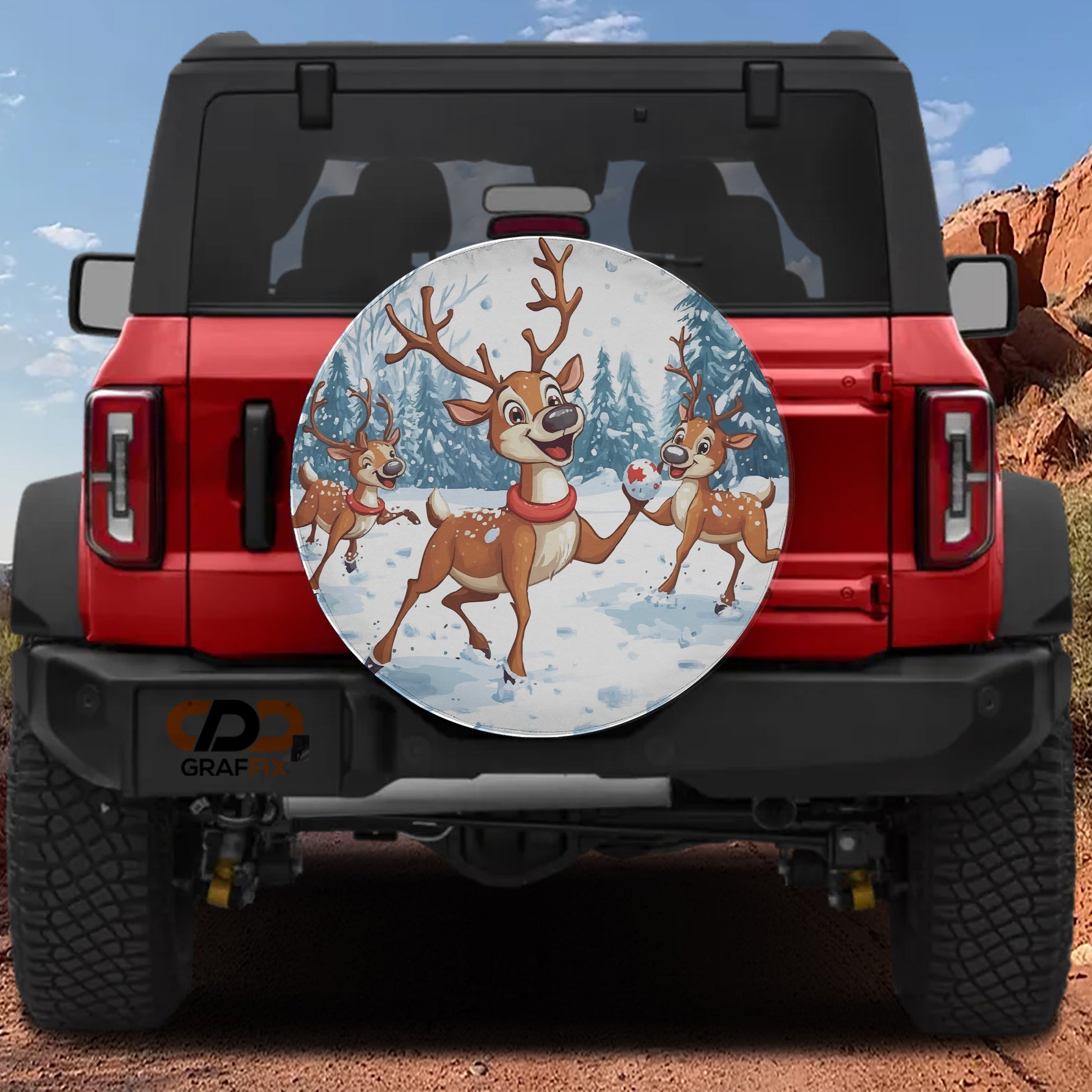 A red Jeep Wrangler with a large, round spare tire featuring a cartoon image of three deer in a snowy forest.