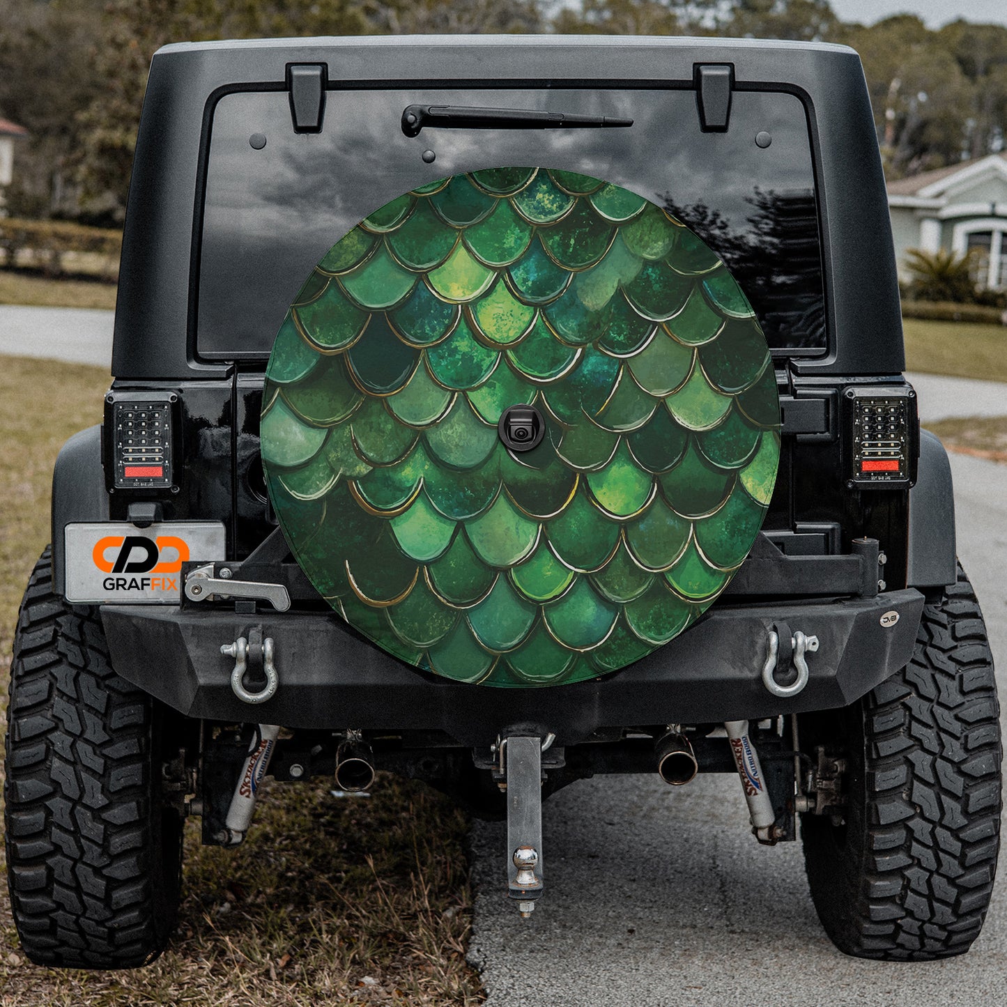 a green fish tail pattern on the back of a jeep