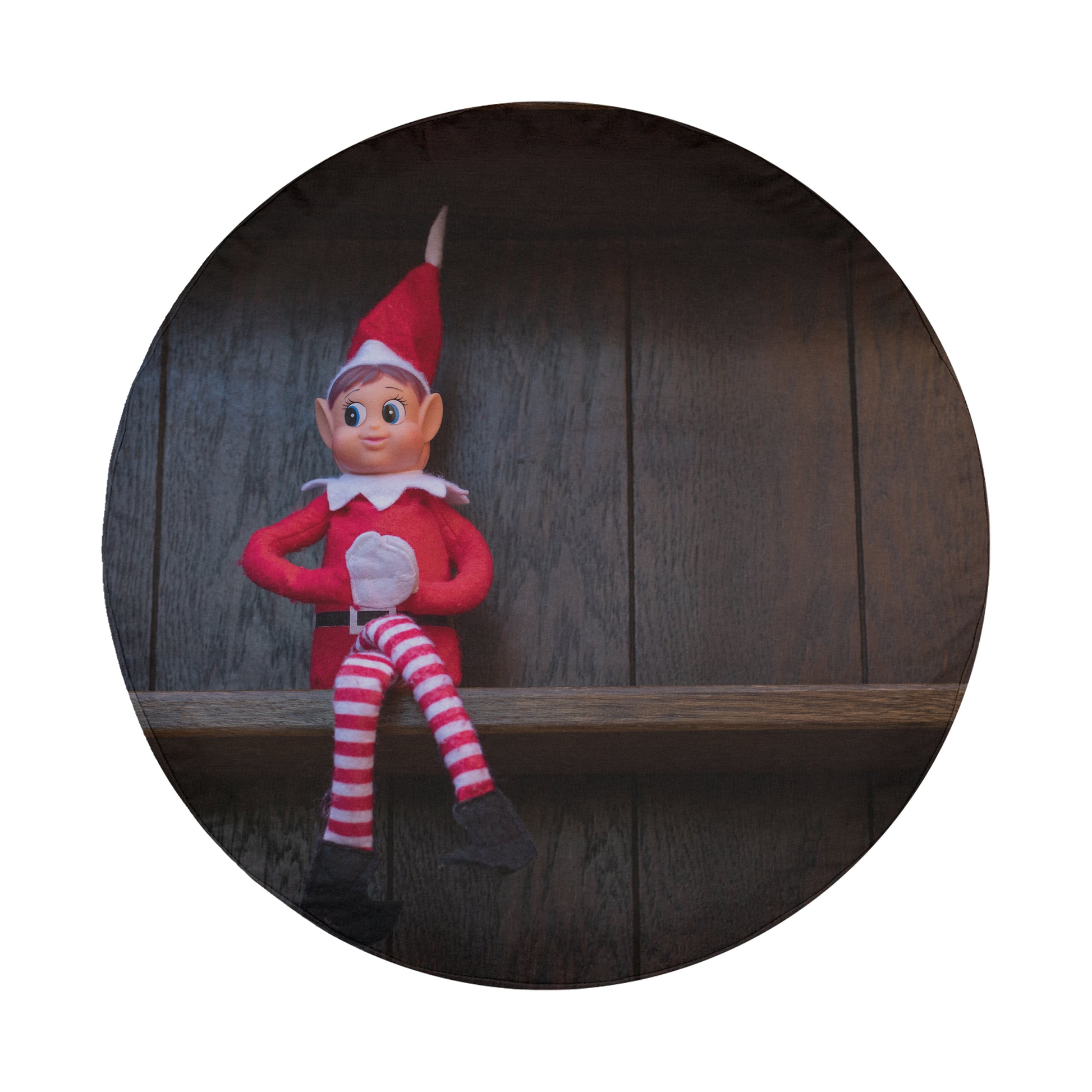A red and white striped elf figurine is sitting on a wooden shelf against a dark background.