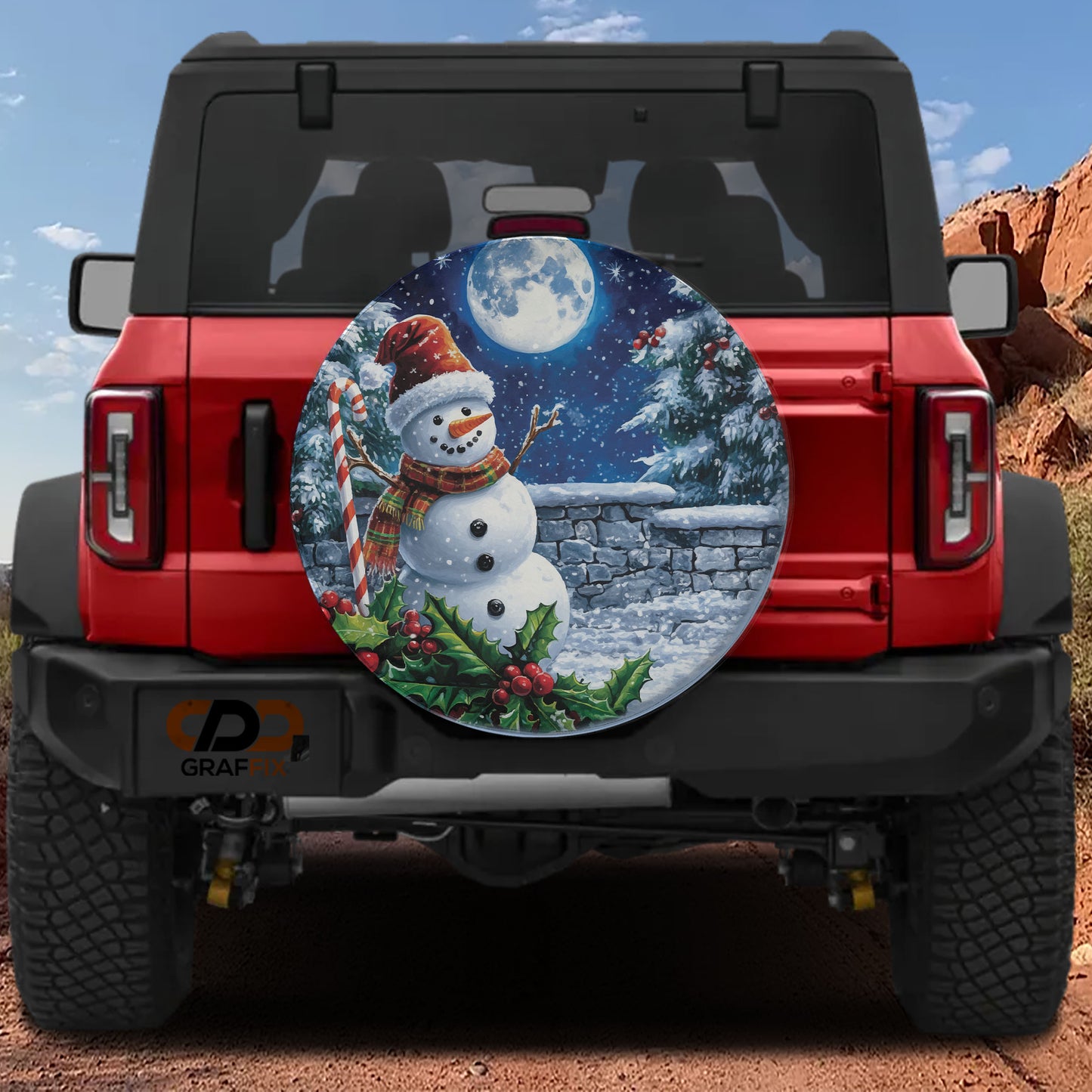 A red Jeep Wrangler with a snowman decoration on the rear window, set against a snowy mountain landscape under a full moon.