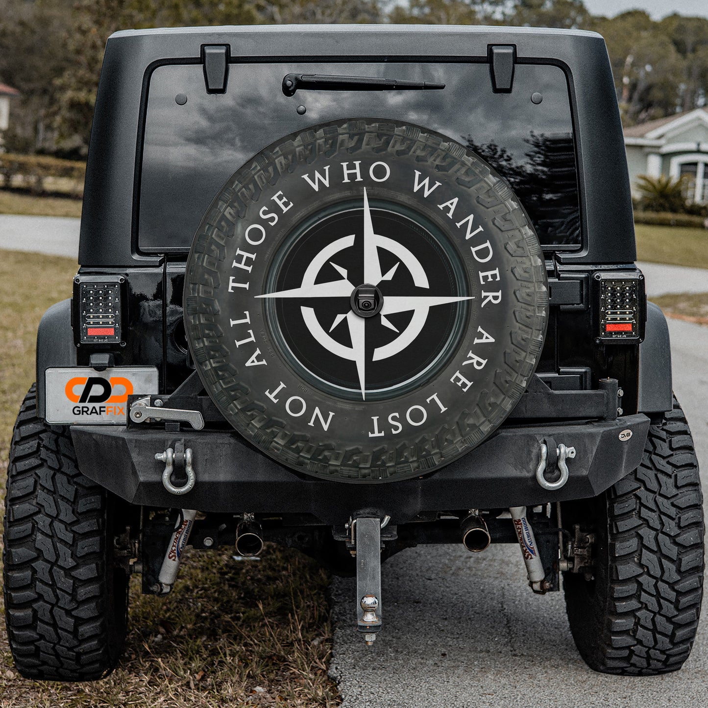 a black Jeep Wrangler with a large spare tire attached to the rear of the vehicle.