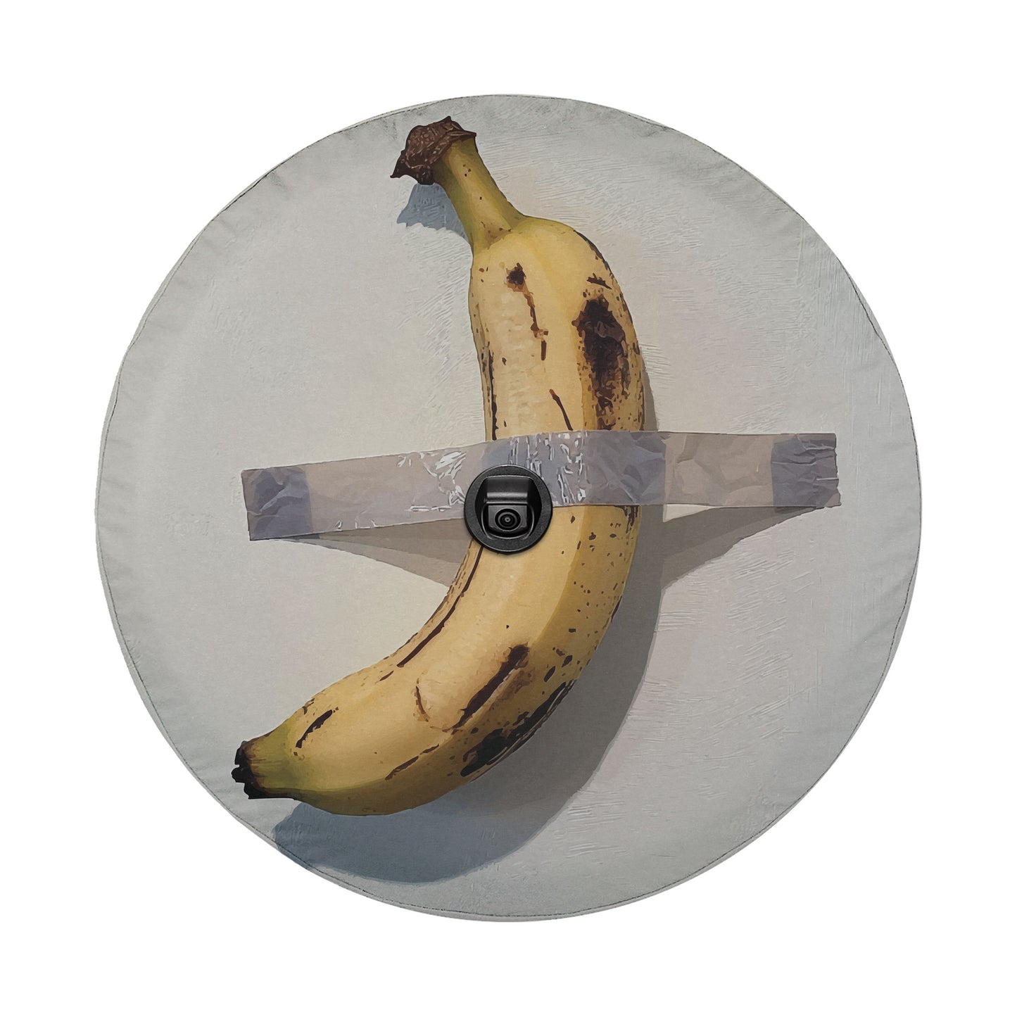 A ripe banana with brown spots is taped to a white plate, with a black camera attached to the tape.