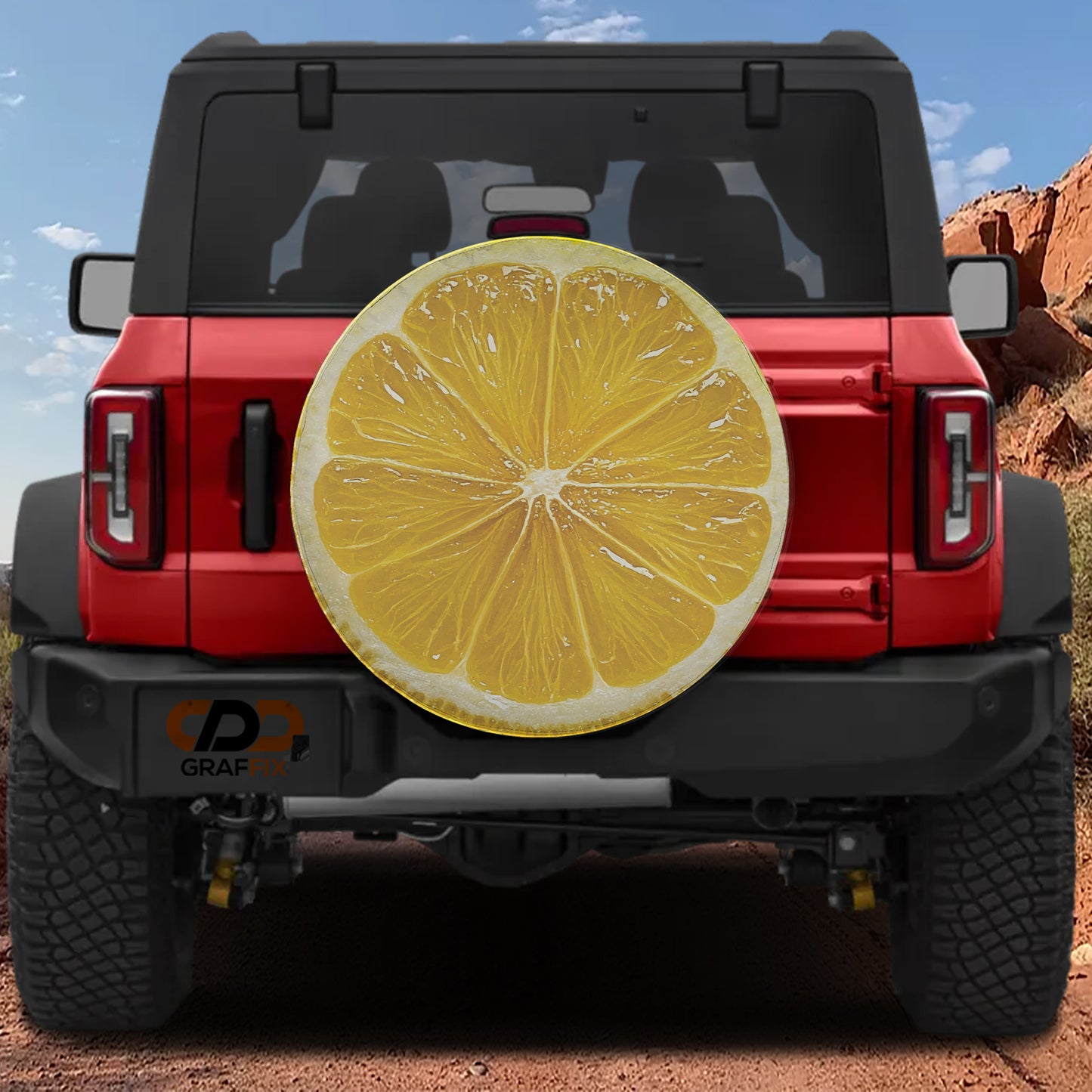 A red Jeep Wrangler with a large, vibrant yellow lemon graphic on the rear window.