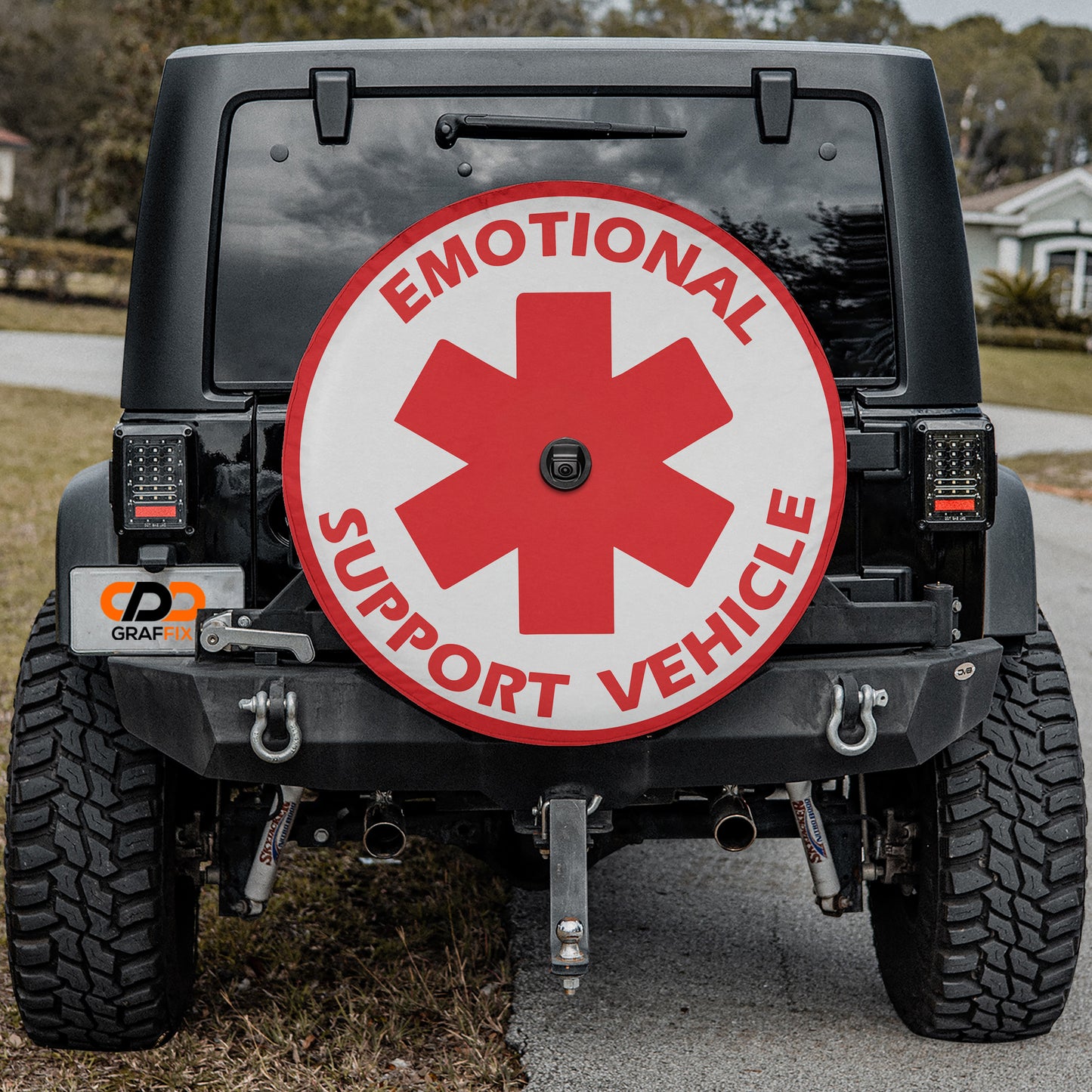 the back of a black Jeep Wrangler with a large red and white sign on the rear window that says "Emotional Support Vehicle".