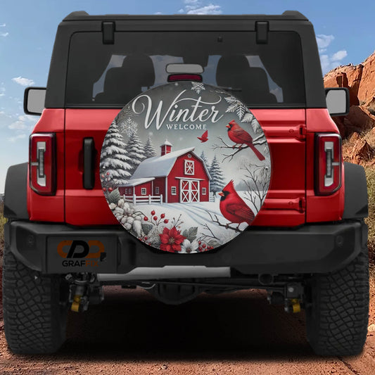 A red Jeep Wrangler with a winter-themed spare tire cover featuring a red barn, snow, and red birds.