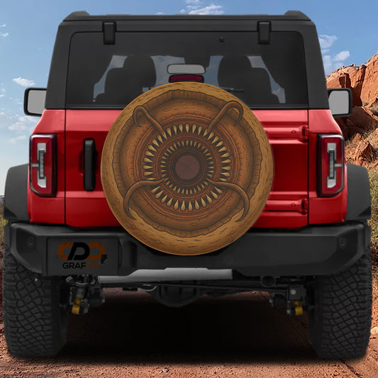 A red Jeep Wrangler with a large, decorative spare tire attached to the rear.