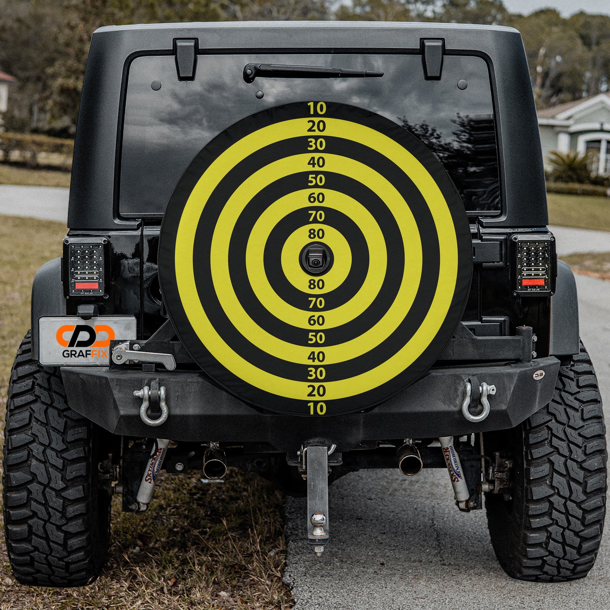 a yellow and black tire cover on a black jeep