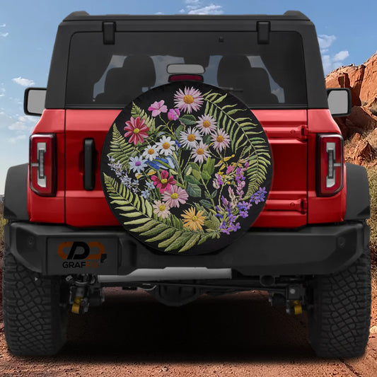 A red Jeep Wrangler with a large floral wheel cover attached to the rear of the vehicle.