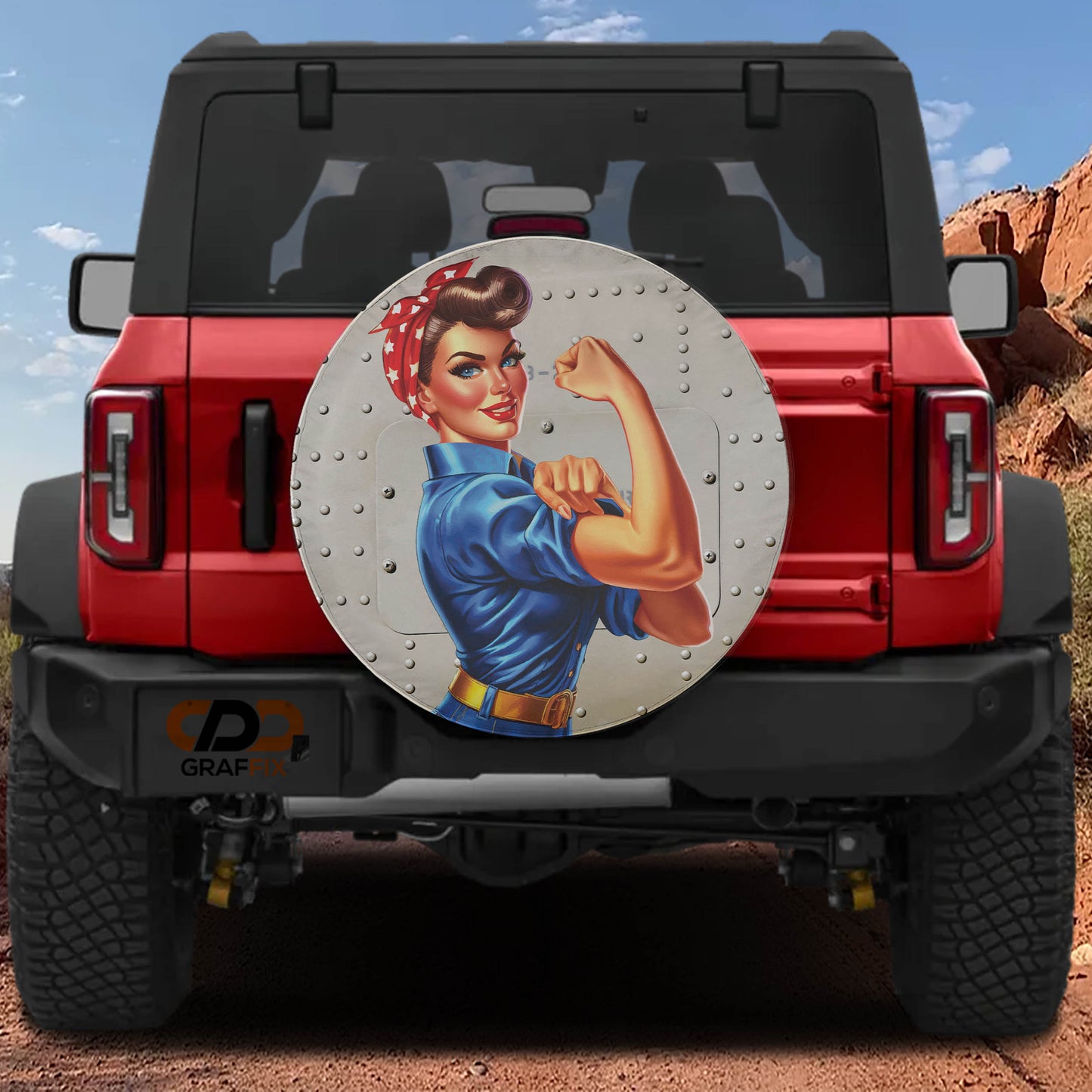 a red Jeep Wrangler with a large, round decal of a woman with a determined expression on the rear window.