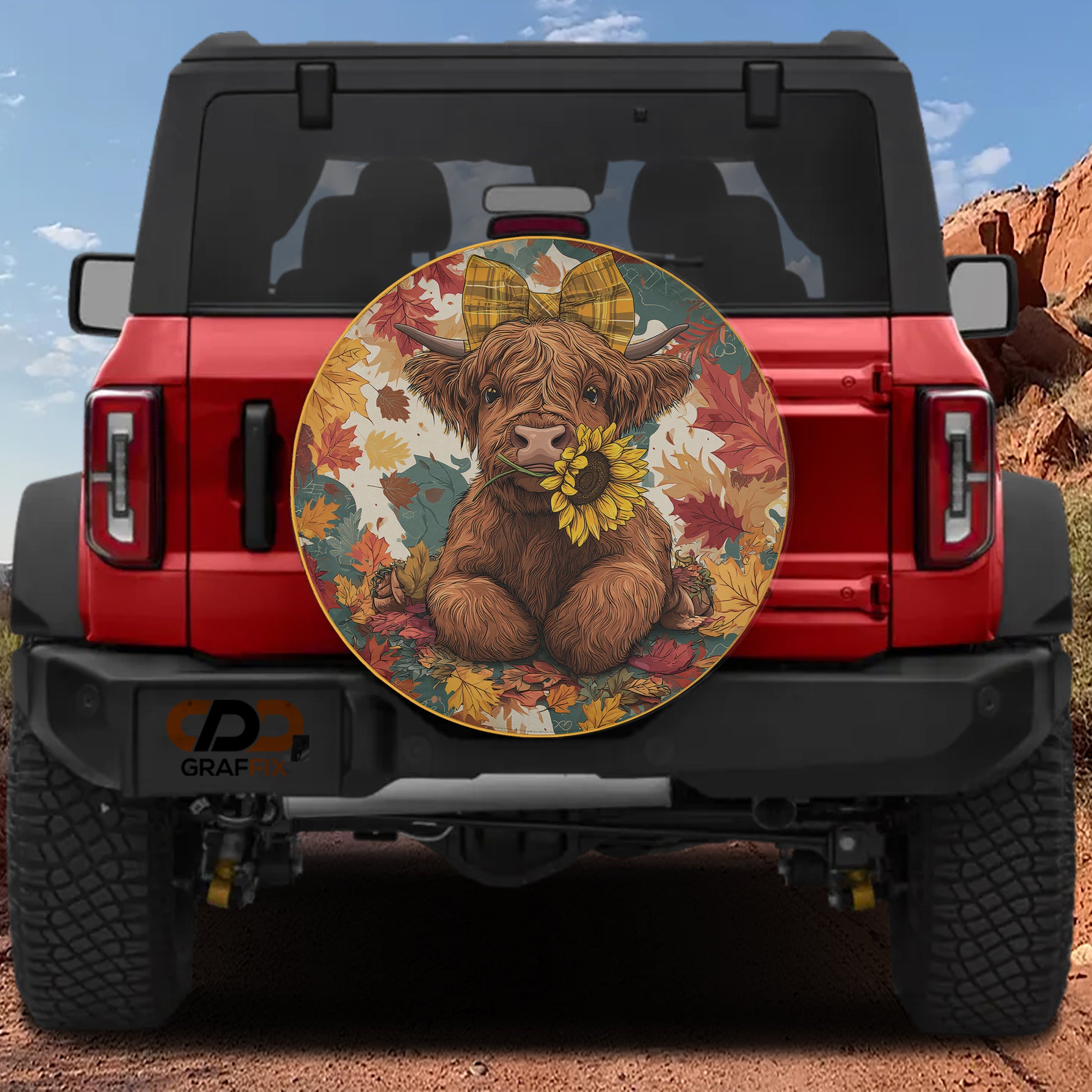 a red Jeep Wrangler with a large, colorful wheel cover depicting a cow with a bow on its head.