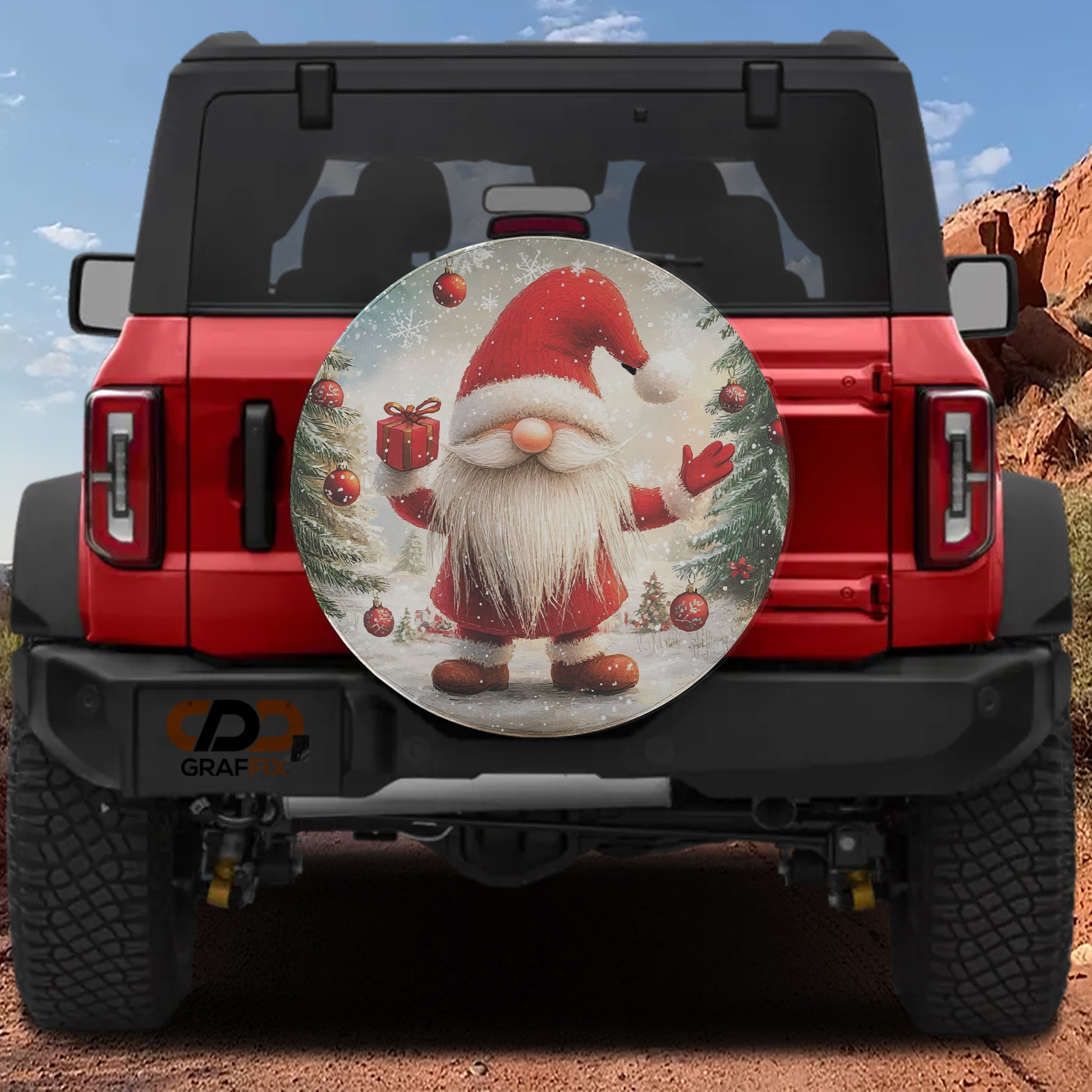 A red Jeep Wrangler with a Santa Claus-themed spare tire cover attached to the rear.