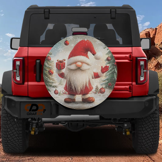 A red Jeep Wrangler with a Santa Claus-themed spare tire cover attached to the rear.