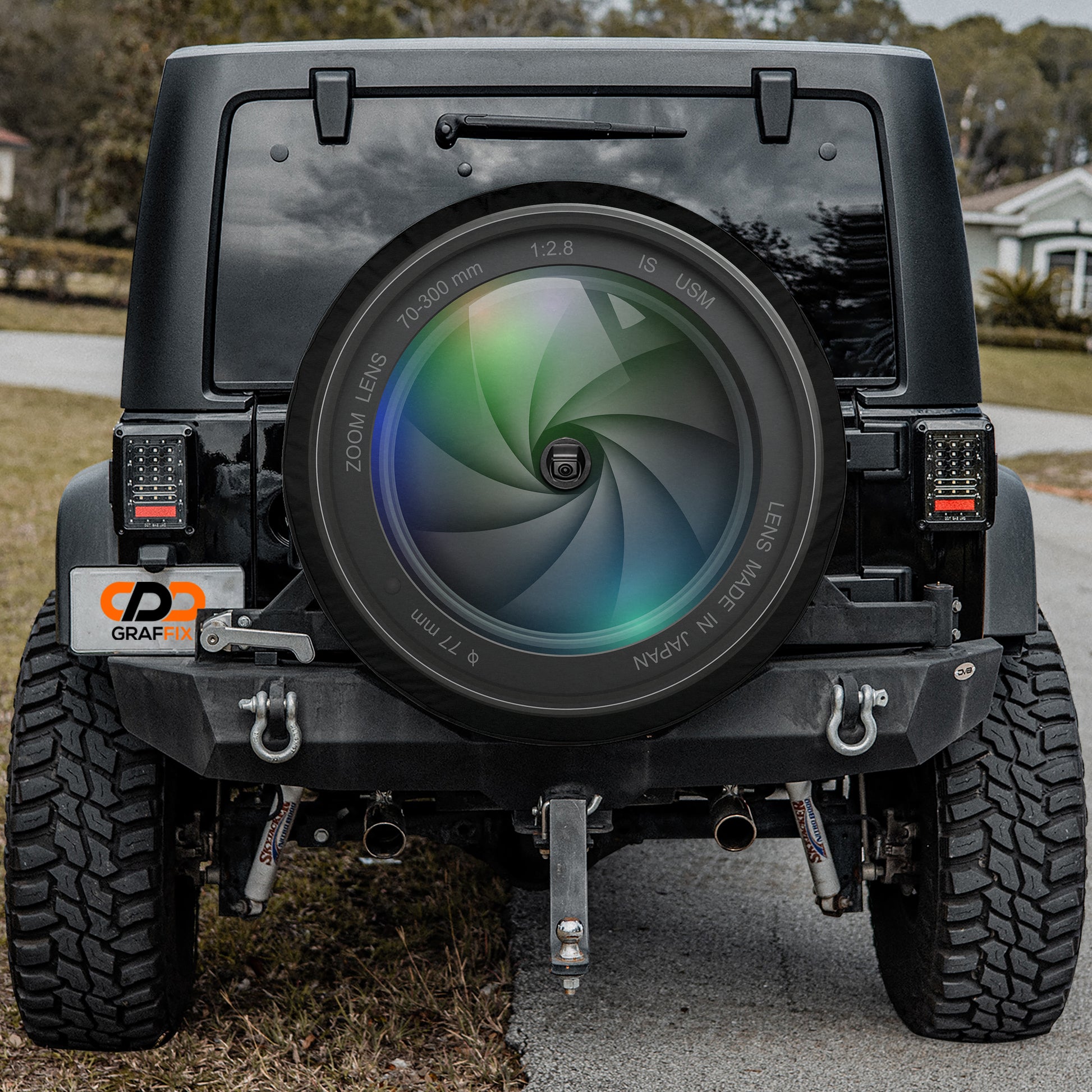 a black jeep with a camera lens on the front of it
