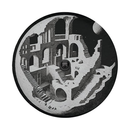 A black and white image depicting a complex architectural structure with multiple levels, arches, and staircases, creating an optical illusion that appears to be a part of a larger, interconnected design.