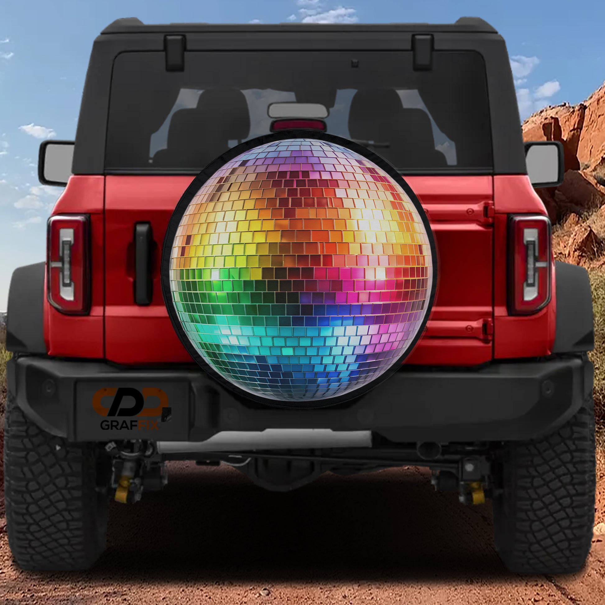 A red Jeep Wrangler with a disco ball mounted on the rear.