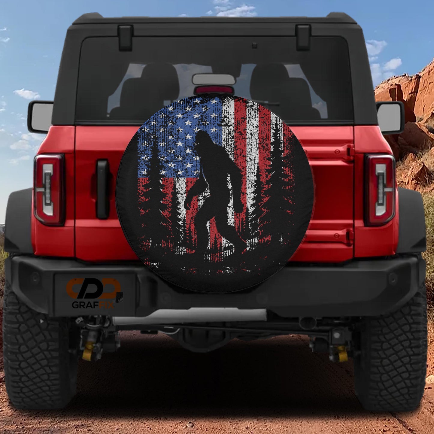a red Jeep Wrangler with a large American flag-themed spare tire cover on the rear of the vehicle.