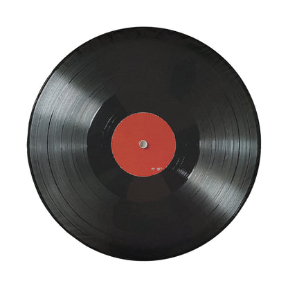 A black vinyl record with a red center is shown against a white background.