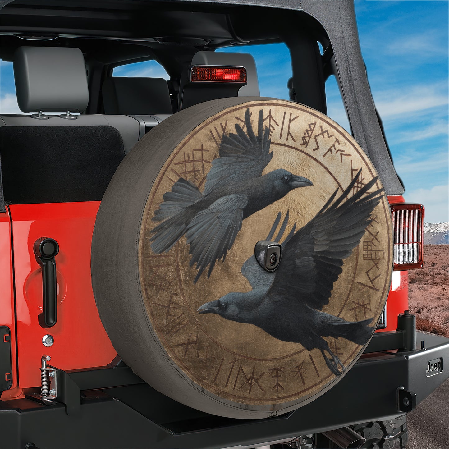 a red Jeep with a large tire cover that has a bird design on it.