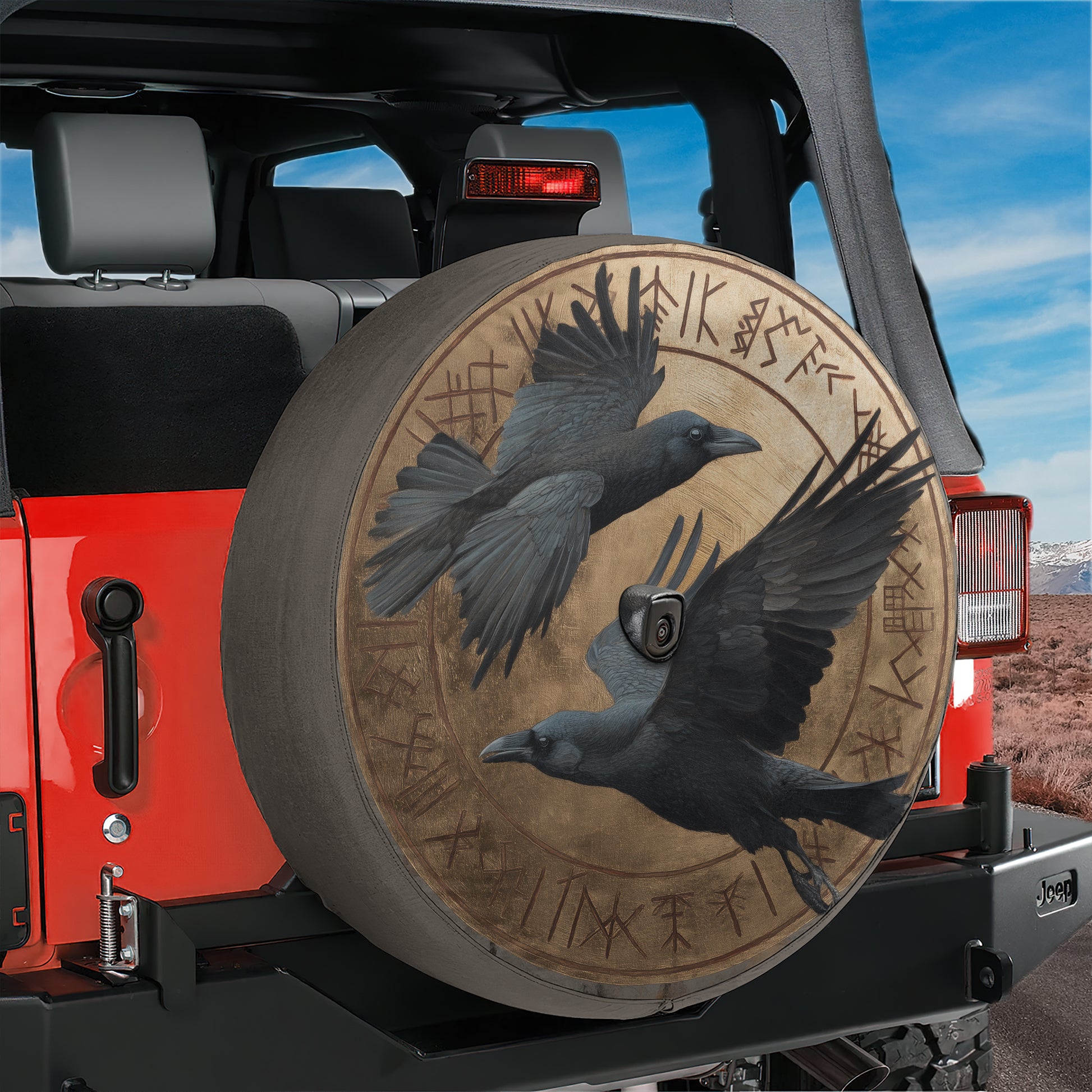 a red Jeep with a large tire cover that has a bird design on it.