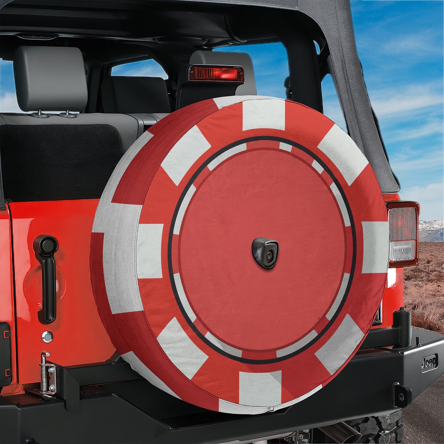 A red and white tire cover is attached to the rear of a Jeep, providing protection for the vehicle's tires.