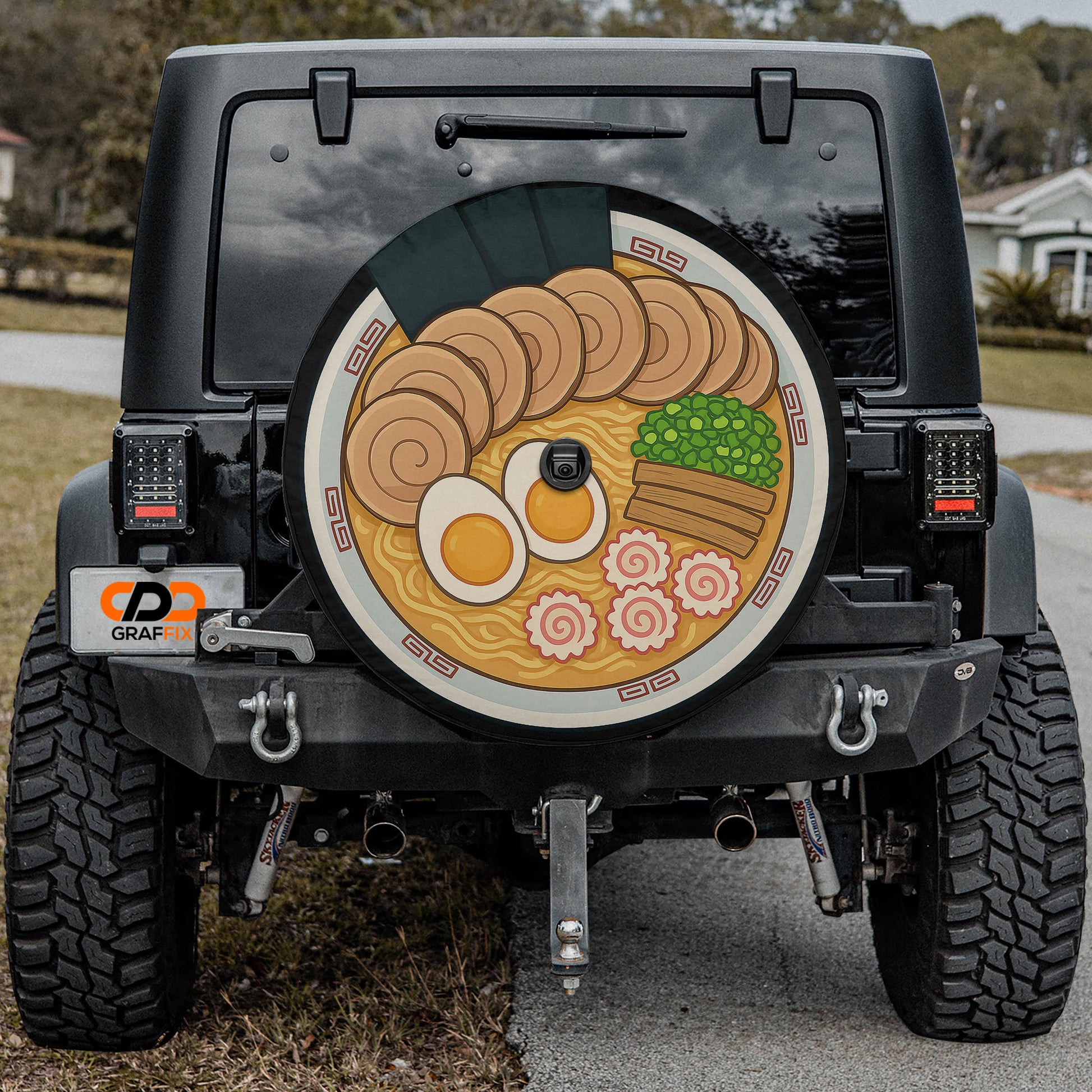 the back of a black Jeep Wrangler with a large, colorful graphic of ramen noodles and various food items on the rear window.