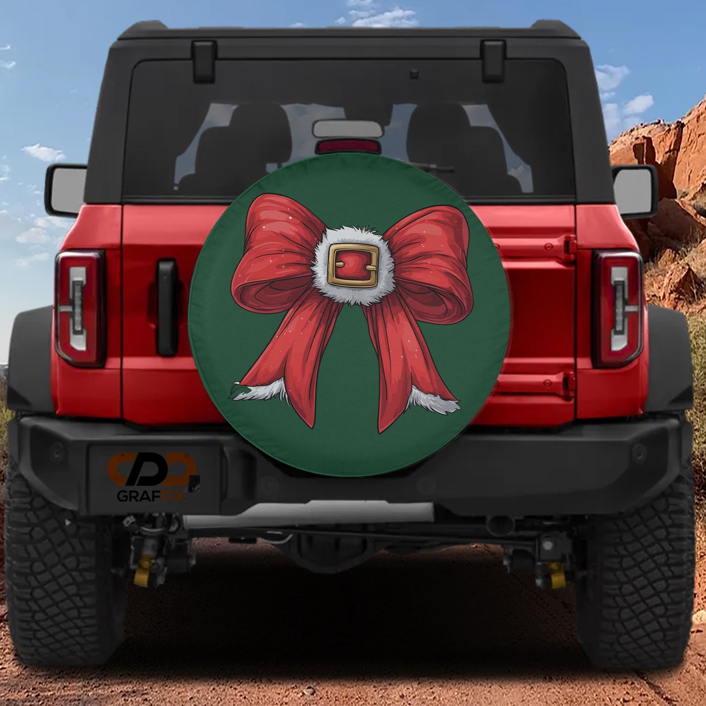 A red Jeep Wrangler with a large green and red bow on the rear window.