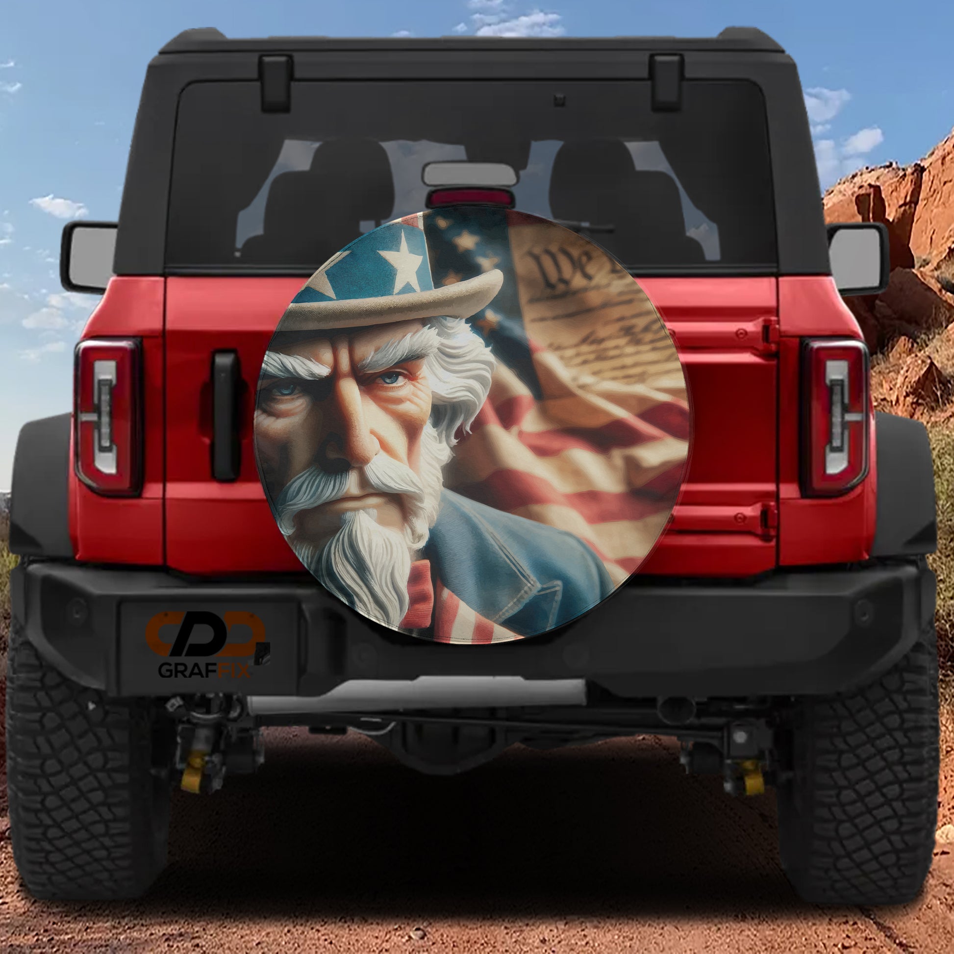 a red Jeep Wrangler with a patriotic-themed spare tire cover depicting a man with a beard and hat, along with an American flag.