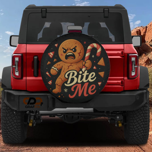 a red Jeep Wrangler with a large tire cover that has a cartoon character and the text "Bite Me" printed on it.