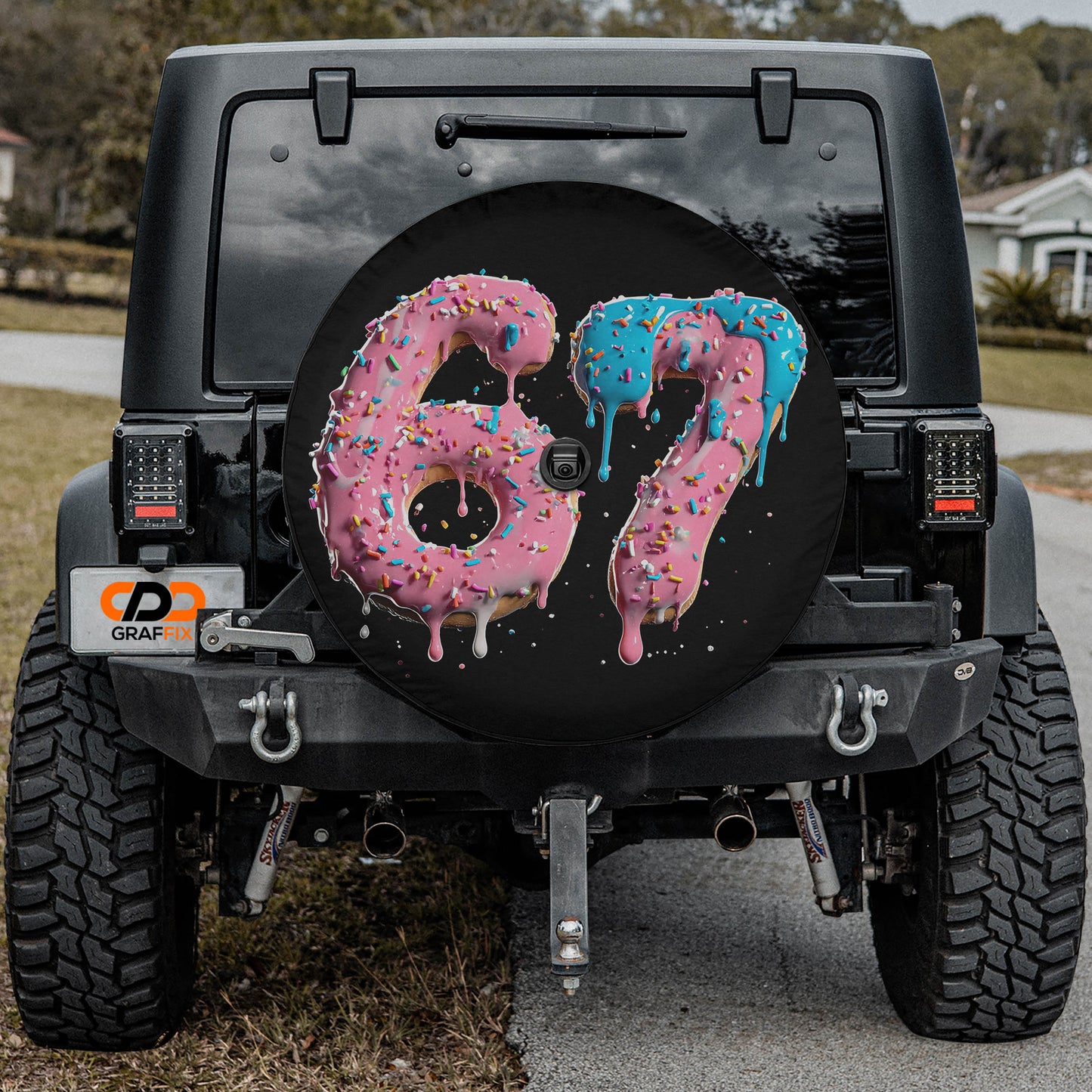 a black Jeep Wrangler with a large rear wheel cover that has a design of the number "67" made of frosted and sprinkled doughnuts.