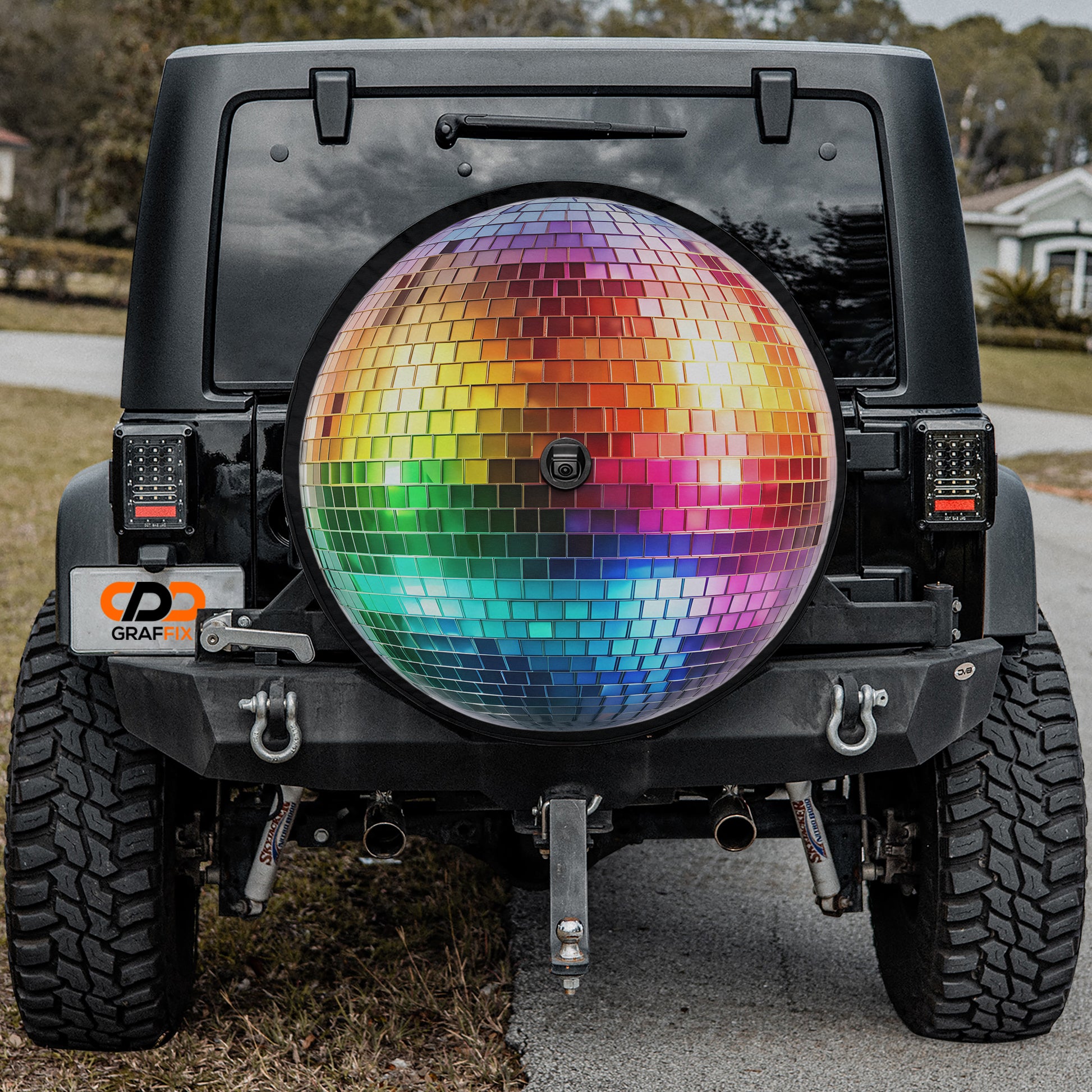 a black Jeep Wrangler with a large, colorful disco ball attached to the rear of the vehicle.