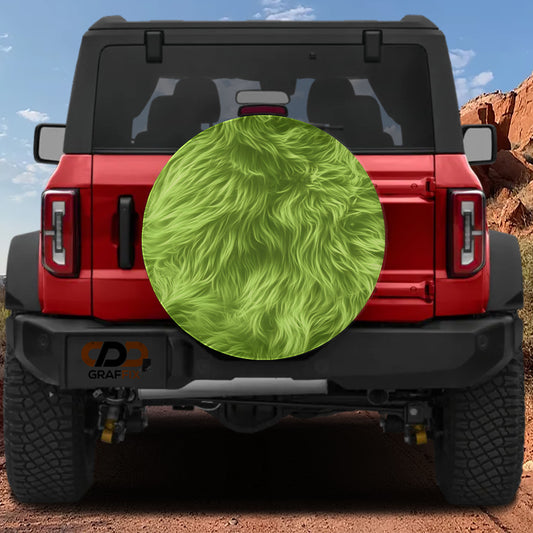 A red Jeep Wrangler with a large green fuzzy object on the rear window.