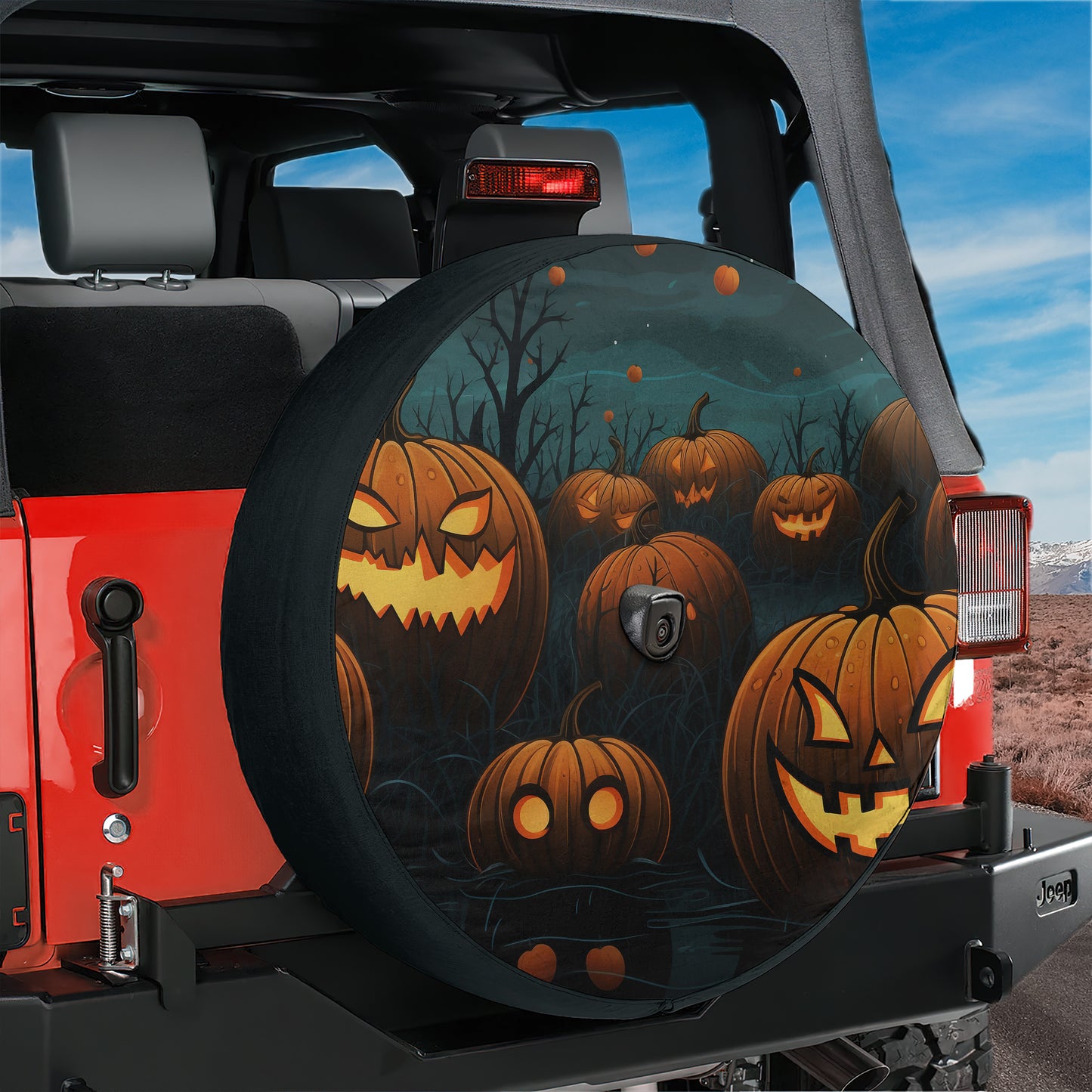 A Jeep vehicle with a Halloween-themed spare tire cover featuring jack-o-lanterns and a spooky forest landscape.