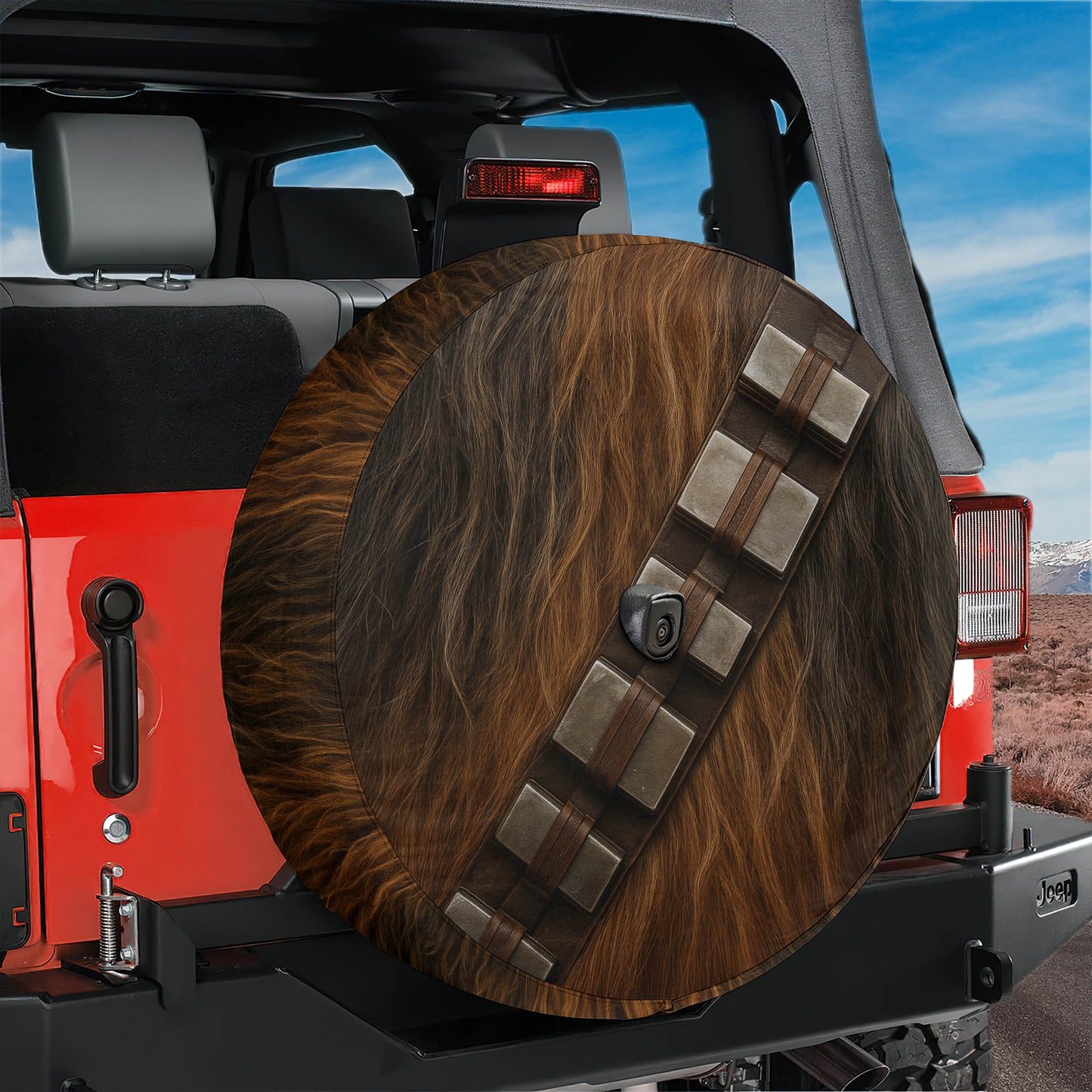 A Jeep Wrangler with a large wheel cover featuring Chewbacca's fur design.