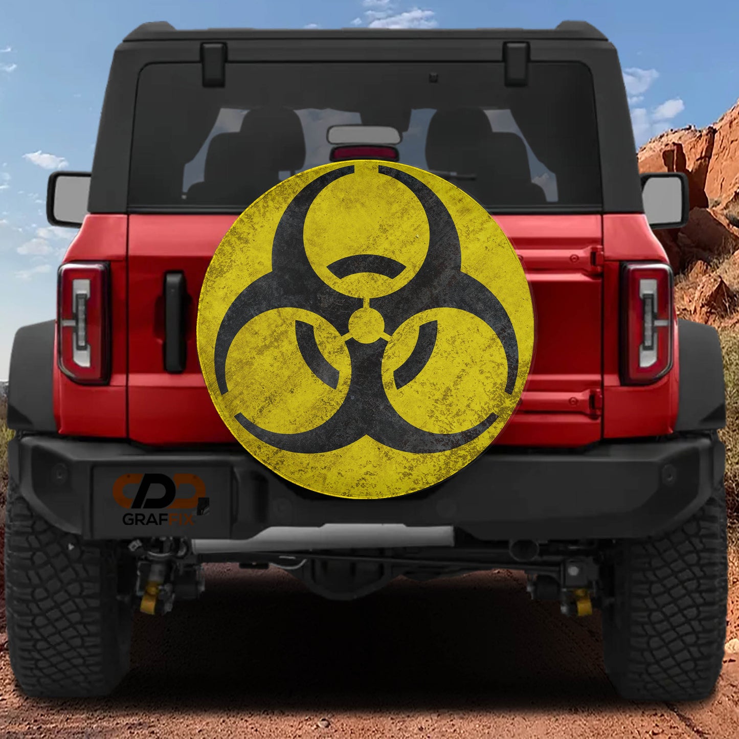 a red Jeep Wrangler with a large, worn-out biohazard symbol on the rear of the vehicle.