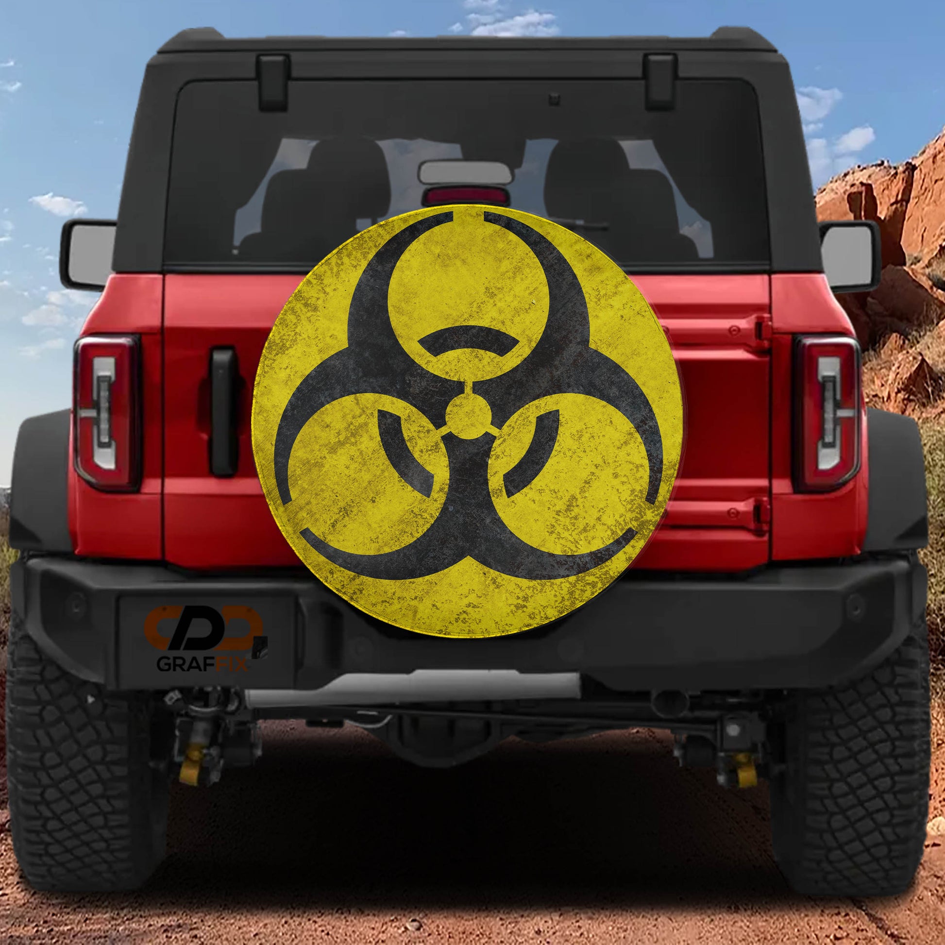 a red Jeep Wrangler with a large, worn-out biohazard symbol on the rear of the vehicle.