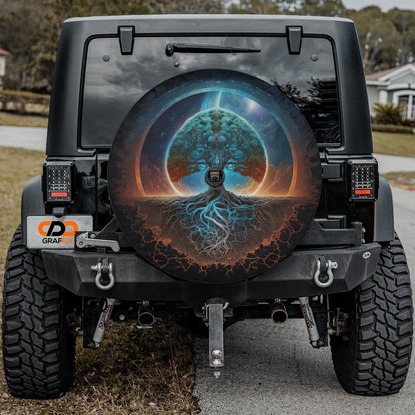a black Jeep Wrangler with a large tree design on the rear window.
