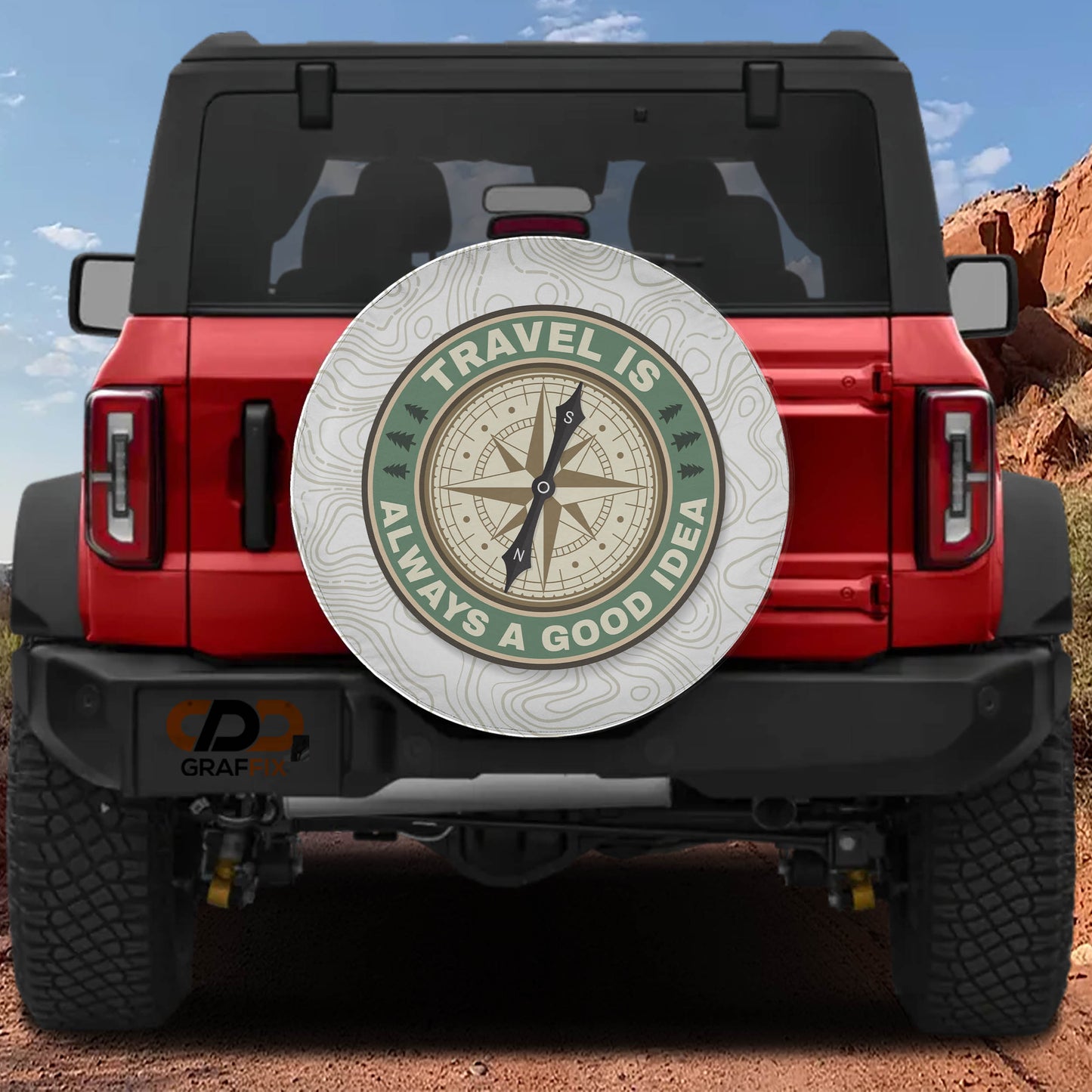 a red Jeep Wrangler with a compass-themed spare tire cover on the rear of the vehicle.