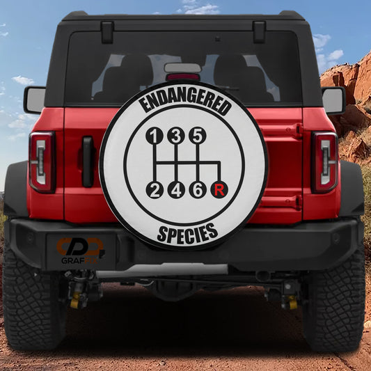 a red Jeep Wrangler with a custom gear shift cover that reads "Endangered Species" and displays a gear shift diagram.