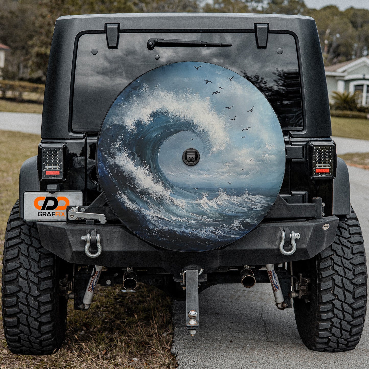 a tire cover with a picture of a wave on it