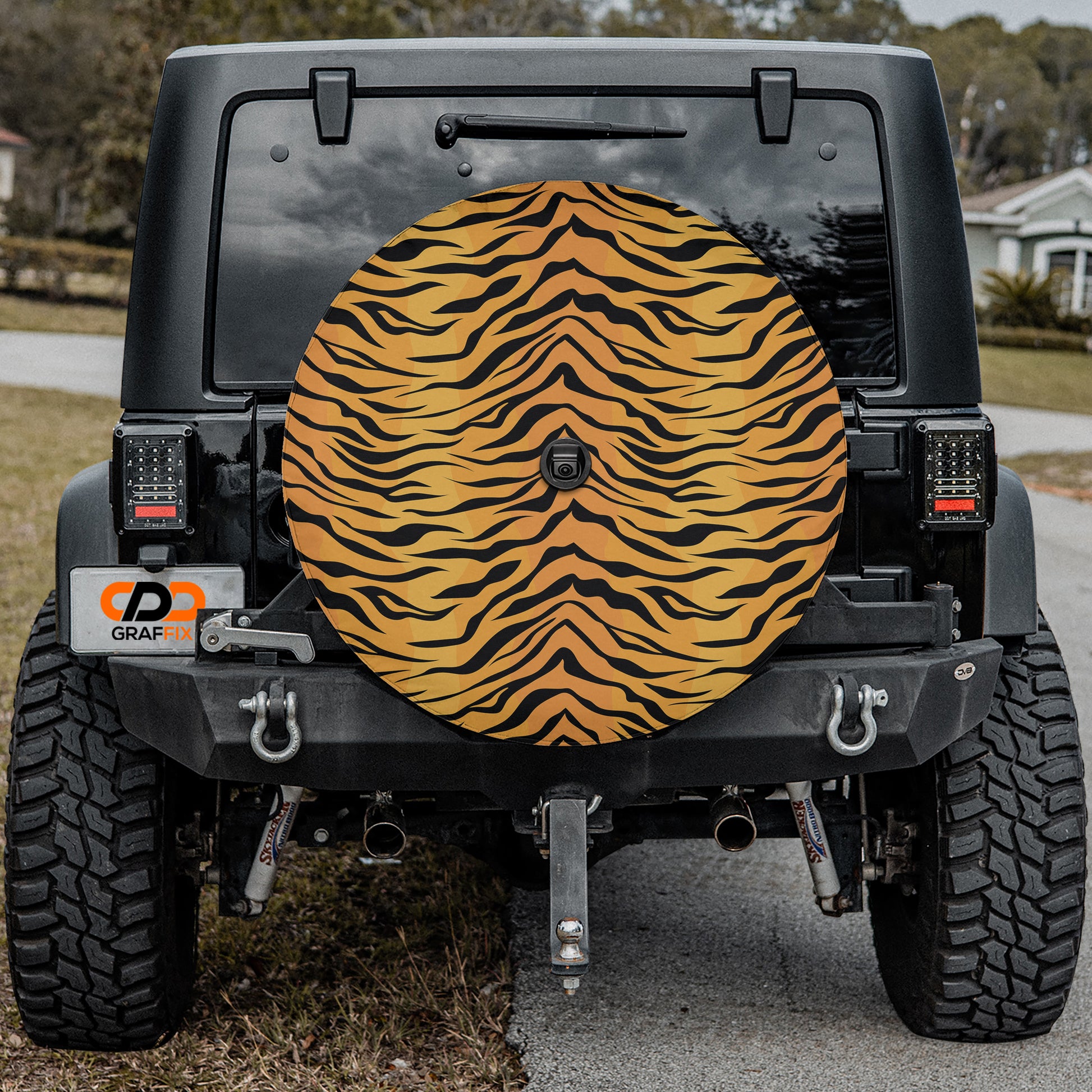 a tiger print tire cover on the back of a jeep
